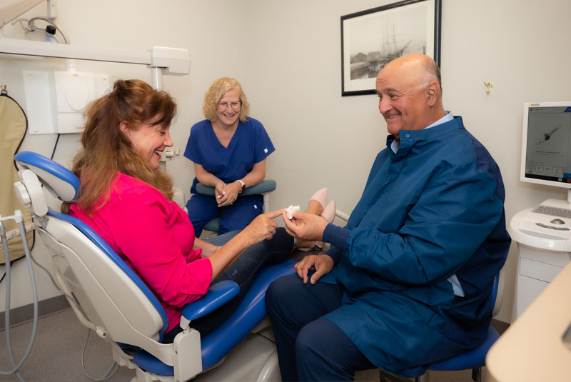 dr drew showing model to patient dentist